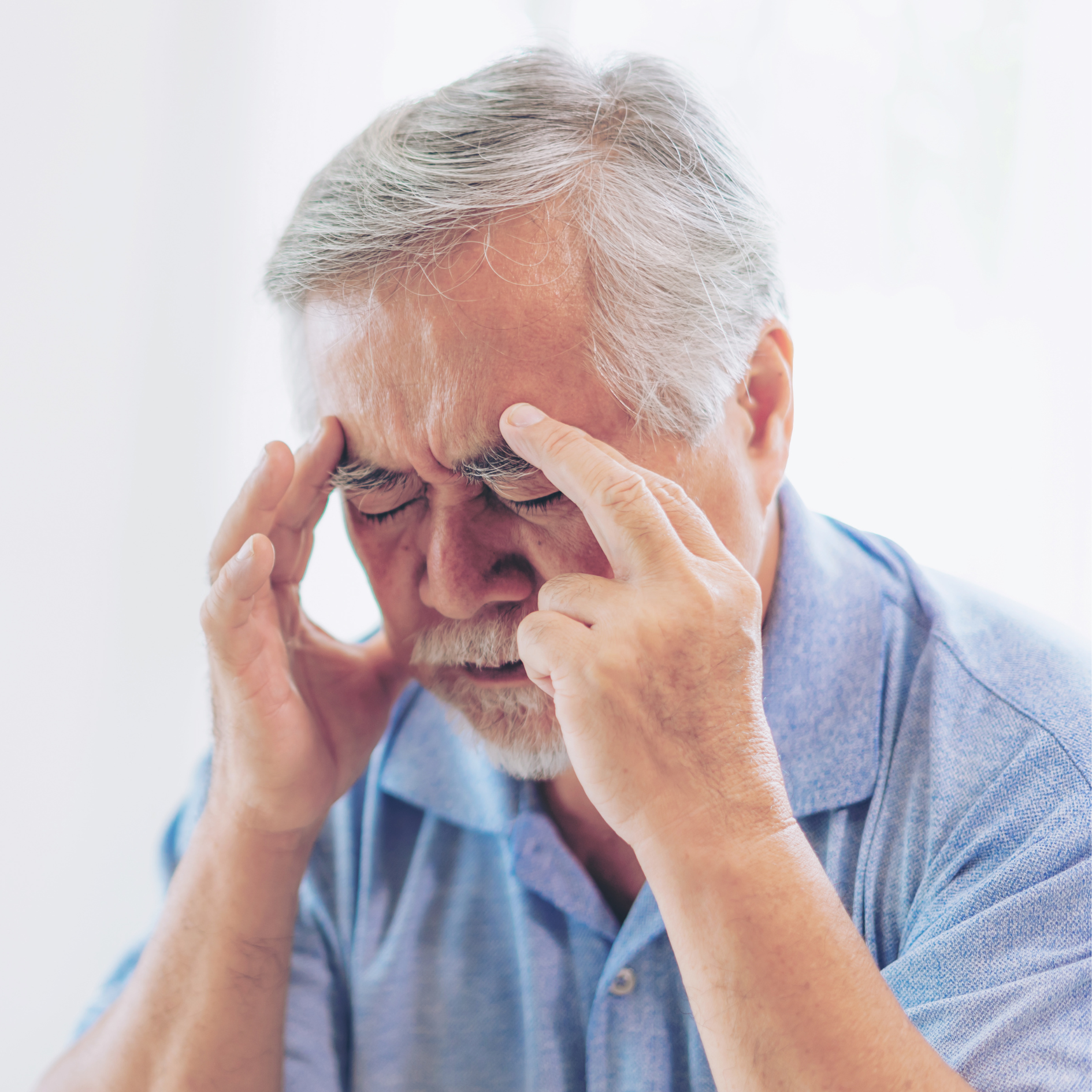 man touching his head